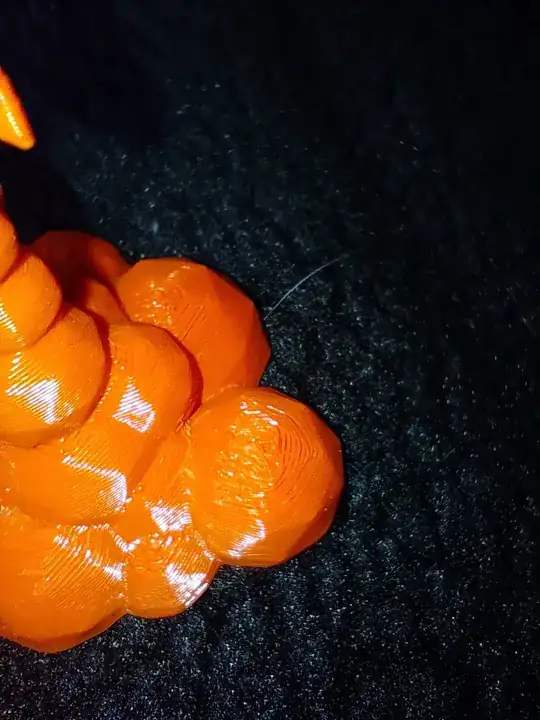 Photo of a 3D printed model with printing errors on the top