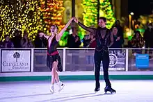 Yehor Yehorov ice skating  with his partner Molly Cesanek in Cleveland Public Square at Christmas time